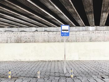 Bus stop under a bridge