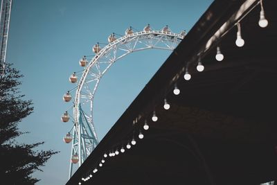 Low angle view of ferris wheel against clear sky