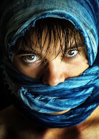 Close-up portrait of woman wrapped in scarf