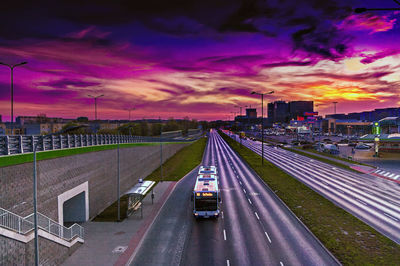 High angle view of cars on street against dramatic sky