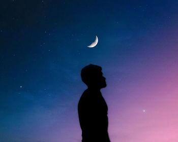 Low angle view of silhouette man against sky at night