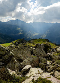 Scenic view of mountains against cloudy sky