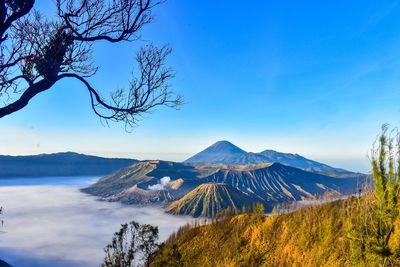 Scenic view of mountains against blue sky
