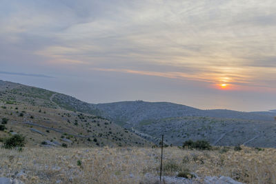 Scenic view of landscape against sky during sunset