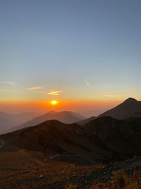 Scenic view of mountains against sky during sunset