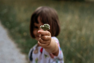 Close-up of girl holding flower