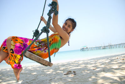 Full length of woman on beach against sky