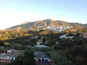 Town by buildings against clear sky