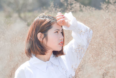 Woman looking away against plants