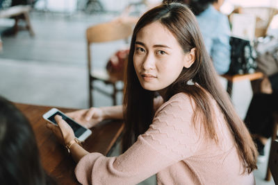 Portrait of mature woman using mobile phone