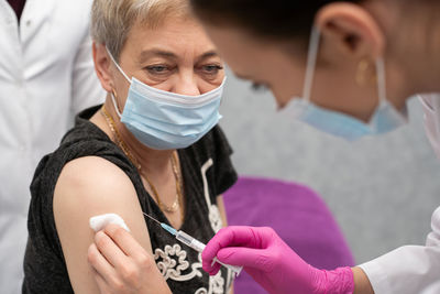 Midsection of woman wearing mask