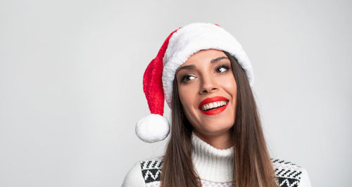Portrait of a smiling young woman against white background