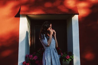 Woman standing on mobile phone