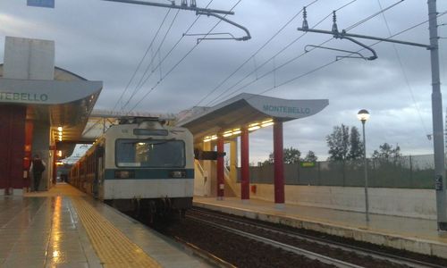 Railroad station platform against sky at dusk