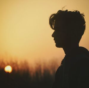 Close-up of silhouette man against sky during sunset