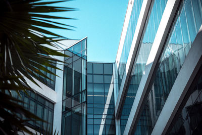 Low angle view of modern buildings against clear blue sky