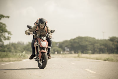 Man riding motorcycle on road