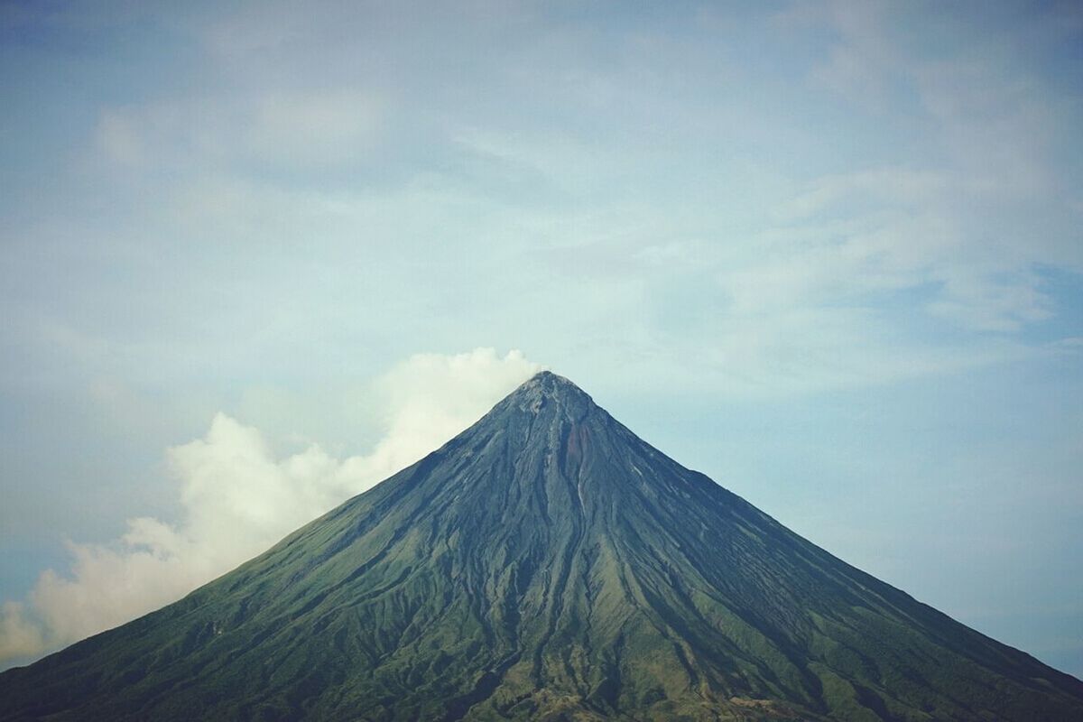 mountain, sky, tranquility, tranquil scene, mountain range, scenics, beauty in nature, cloud - sky, nature, low angle view, cloud, landscape, non-urban scene, idyllic, day, cloudy, outdoors, mountain peak, physical geography, majestic