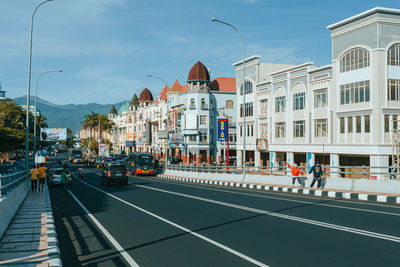 City street by buildings against sky