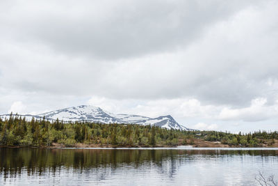 Scenic view of lake and mountains against sky