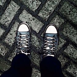 Low section of woman standing on tiled floor