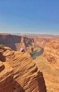 Scenic view of desert against clear blue sky