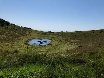 Scenic view of land against clear blue sky