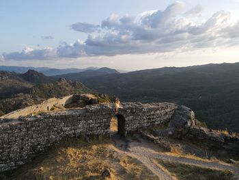 Aerial view of mountain range against cloudy sky