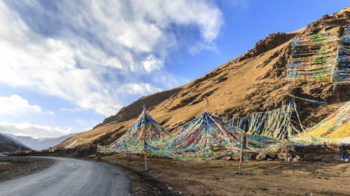 Road by mountain against sky