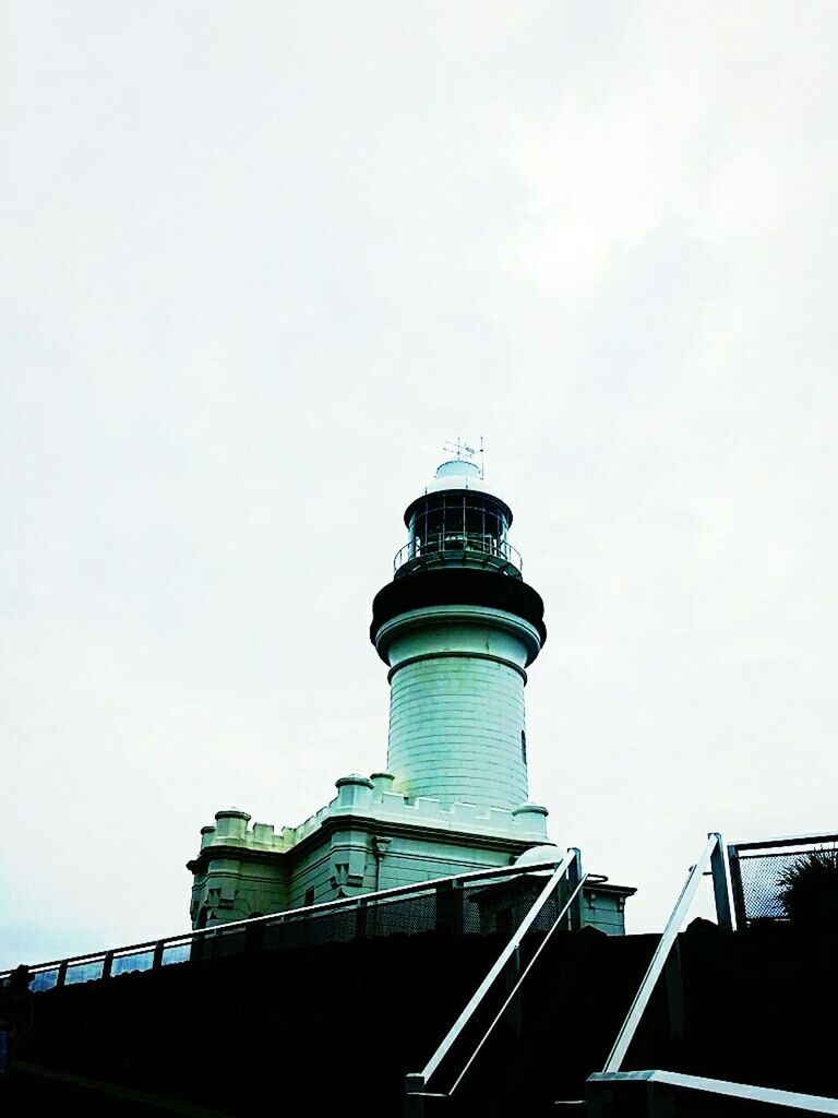 architecture, building exterior, built structure, low angle view, lighthouse, tower, high section, copy space, clear sky, guidance, sky, direction, tall - high, protection, outdoors, day, blue, no people, building, safety