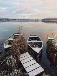 Abandoned boat moored in lake against sky