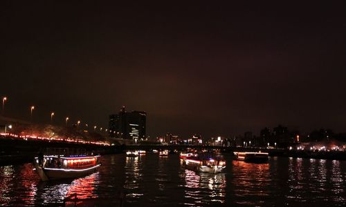 Boats in river at night