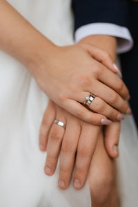 Midsection of couple holding hands