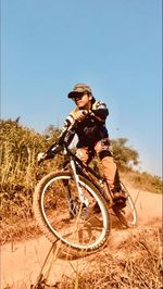 Man riding bicycle on field