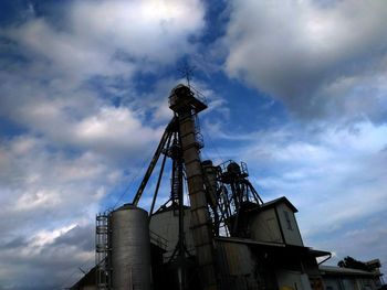 Low angle view of factory against sky