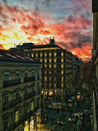 Buildings against cloudy sky at sunset