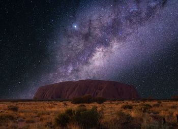 Scenic view of landscape against sky at night