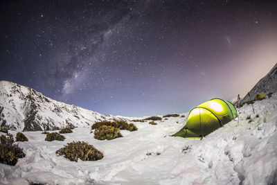 Scenic view of tent against sky at night