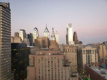 Modern buildings in city against clear sky