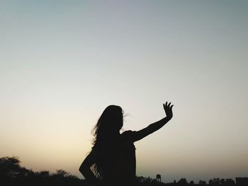 Silhouette man against clear sky during sunset