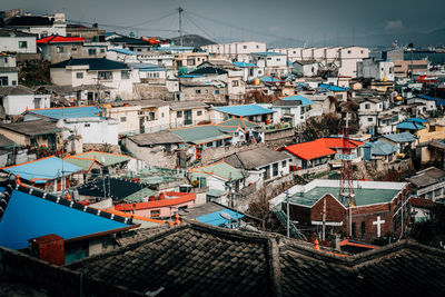 High angle view of houses in town against sky