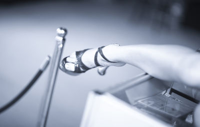 Low section of woman wearing high heels on table