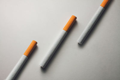 High angle view of cigarette on table against white background