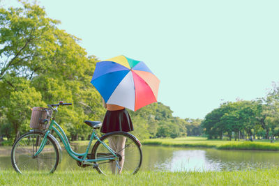Bicycle by umbrella on road during rainy season