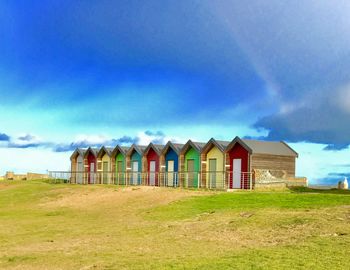 Houses on beach against blue sky