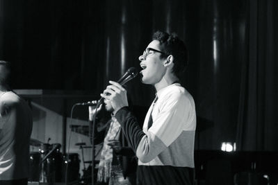 Young man singing at concert