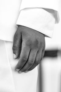 Cropped hand of man holding paper