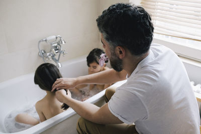 Side view of young woman exercising at home
