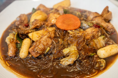 Andong jjimdak on a plate. soy sauce braised chicken in andong jjimdak alley market, south korea