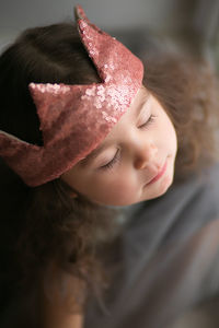 Close-up portrait of cute girl wearing crown